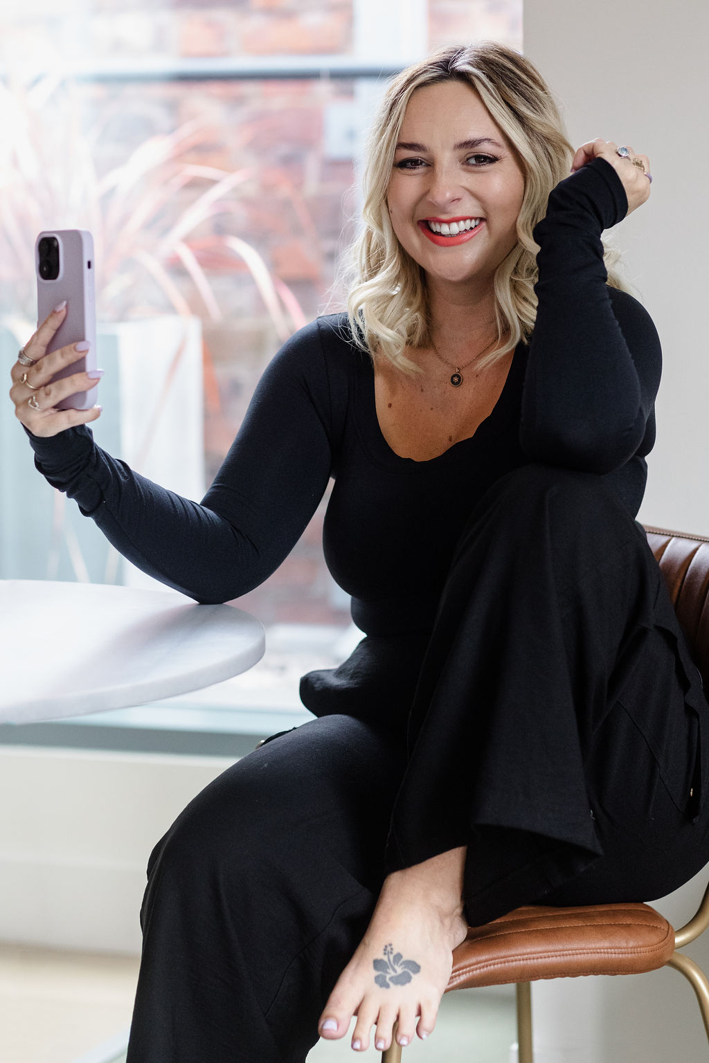 Holly Wood Flourish Mentor Media Bio laughing holding phone